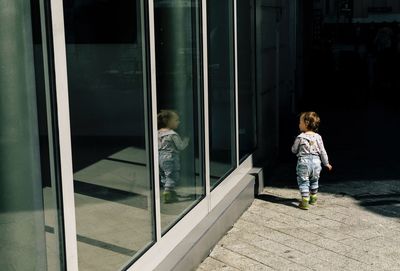 Rear view of child walking by door