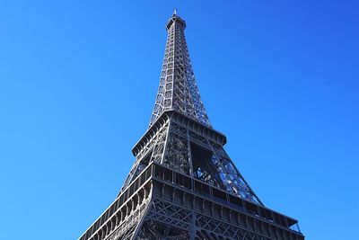 Low angle view of tower against blue sky