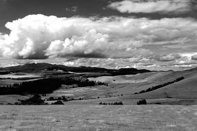 Scenic view of mountains against cloudy sky