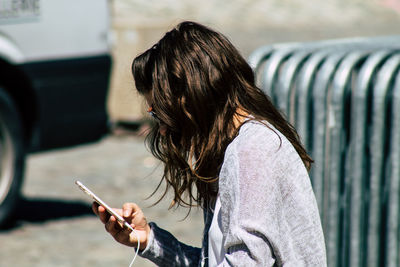 Side view of man using mobile phone