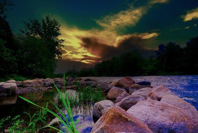 Scenic view of river against sky during sunset