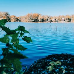 Scenic view of lake against clear blue sky