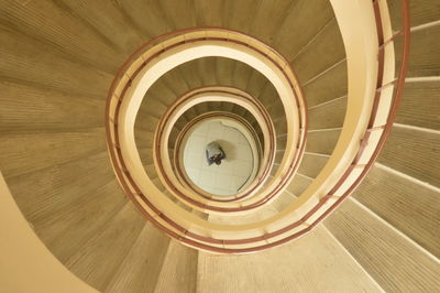 Directly above shot of man by spiral staircase