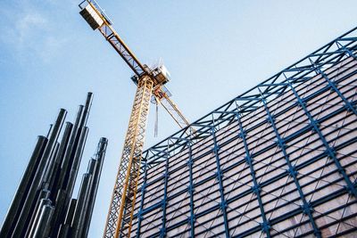 Low angle view of crane against clear sky