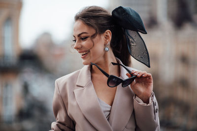 Portrait of smiling woman standing outdoors