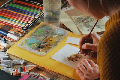 High angle view of woman drawing on paper