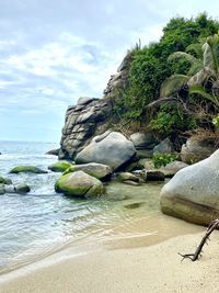 Rocks by sea against sky