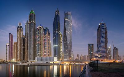 Panoramic view of illuminated buildings in city against sky