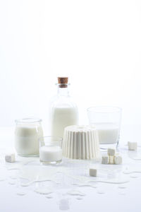 Dairy products on white wood base and white background with copy space. vertical format.