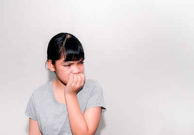 Portrait of teenage boy against wall