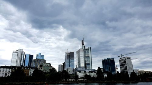 Buildings against cloudy sky