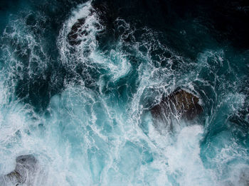 High angle view of waves splashing in sea