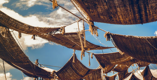 Low angle view of traditional windmill against sky