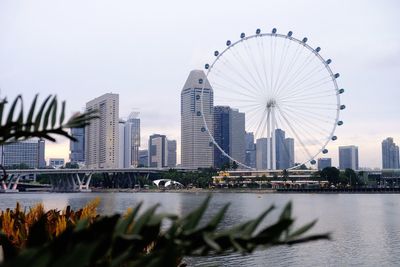 Ferris wheel in city against sky