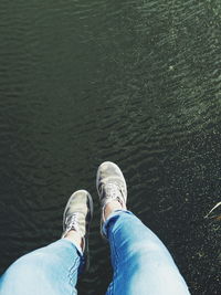 Low section of woman standing in water
