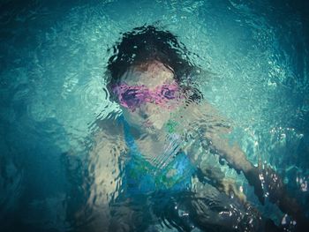 High angle view of girl in rippled swimming pool