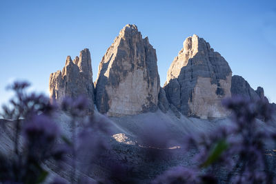 Panoramic view of rocks and mountains against clear blue sky