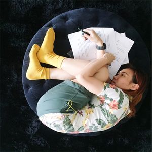 Directly above shot of young woman lying with pen and papers lying on seat