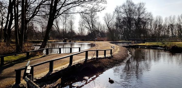 Scenic view of river against sky during winter