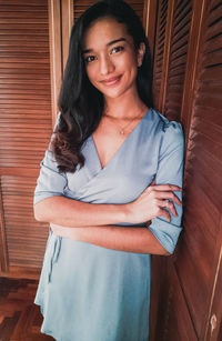 Portrait of a smiling young woman at home