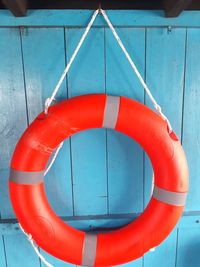 Close-up of red umbrella hanging from swimming pool