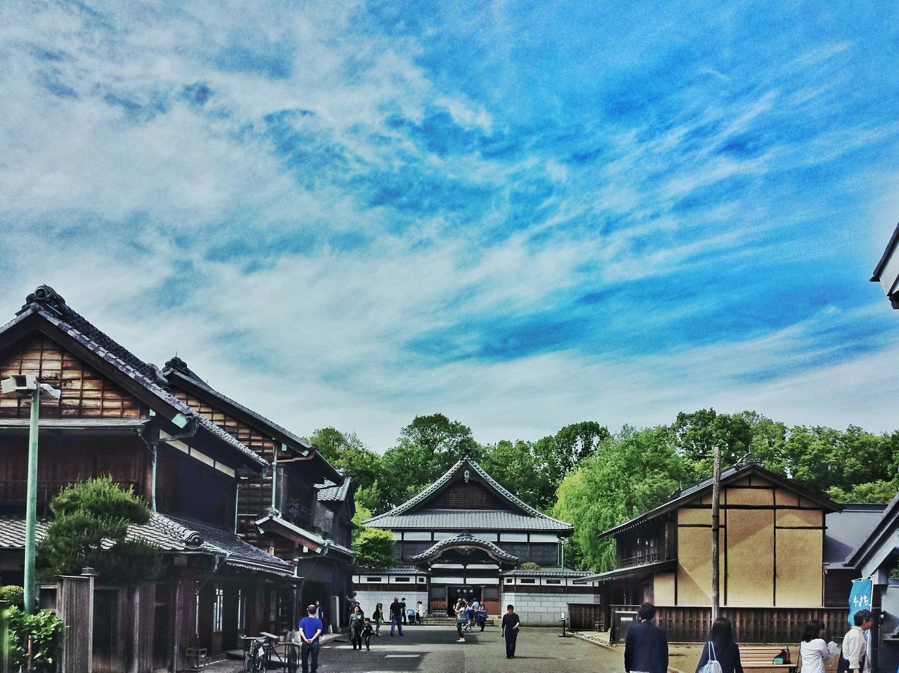 architecture, built structure, building exterior, sky, men, large group of people, person, tree, cloud - sky, lifestyles, cloud, leisure activity, walking, cloudy, day, outdoors, house, mixed age range, city life