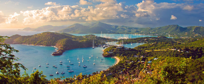 Aerial view of sea and mountains against cloudy sky