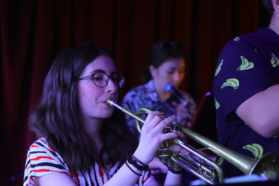 Females playing trumpets on stage