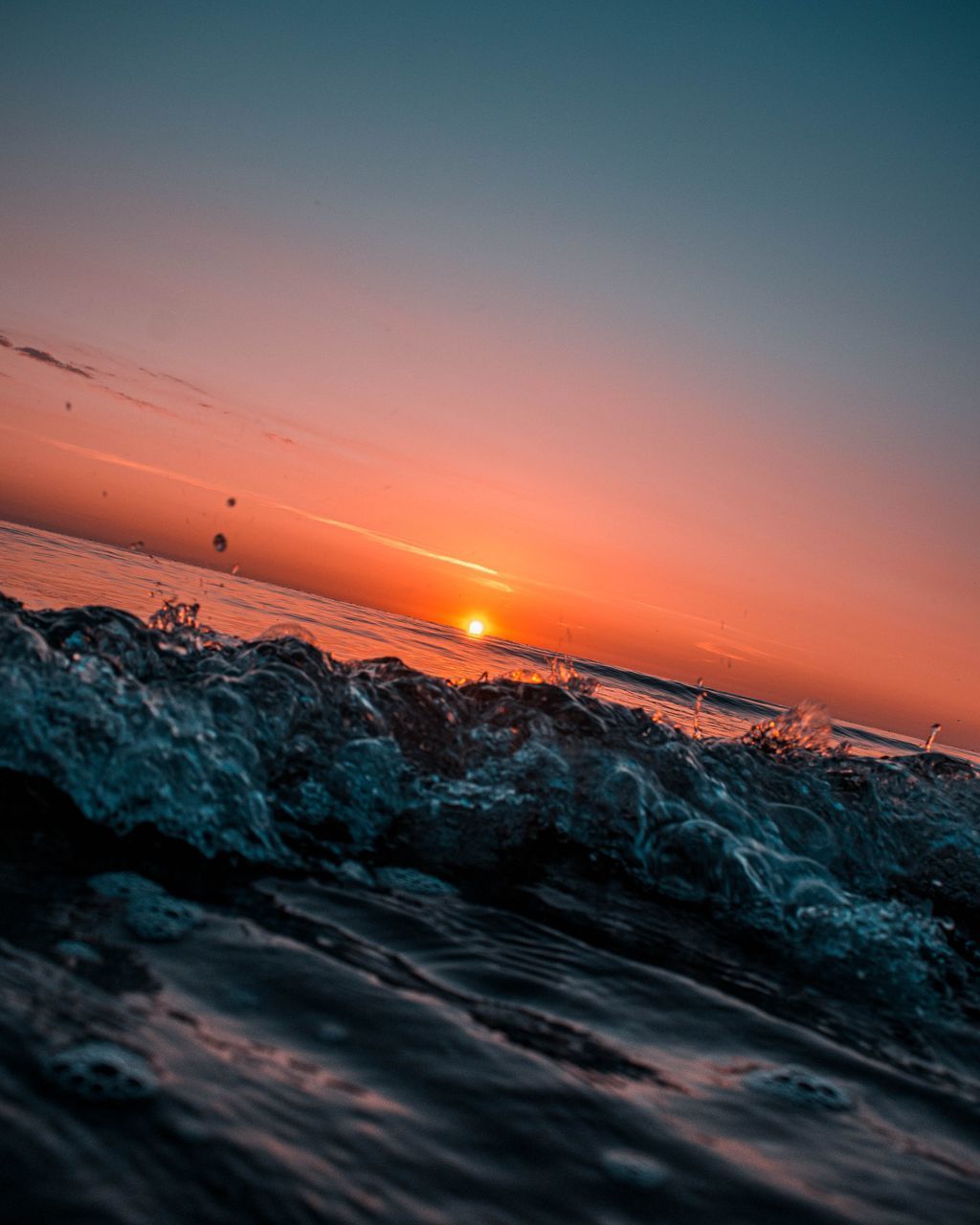 SCENIC VIEW OF SEA AGAINST ORANGE SKY