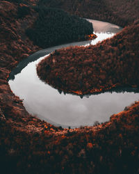 High angle view of lake amidst trees against sky