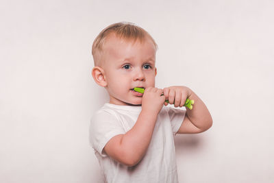 Portrait of cute baby girl against white background