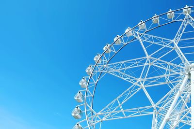 Low angle view of ferris wheel against clear sky