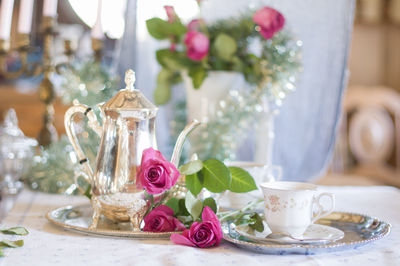 Tea break in english style, vintage silver service against the flowers