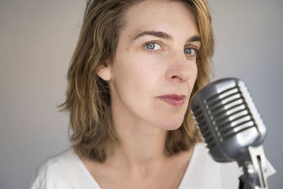 Portrait of beautiful woman with microphone