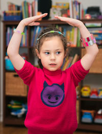 Young girl modeling her bracelets in a ballet stand