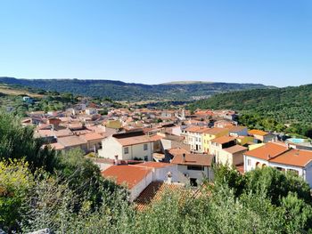 Village of siligo  against hills and clear blue sky