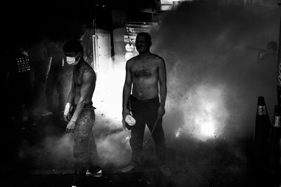 Full length of shirtless man walking in corridor