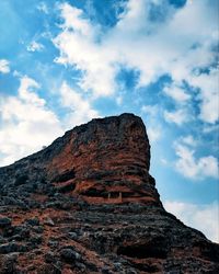 Low angle view of rock formation against sky