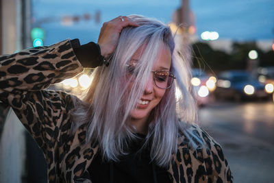 Young woman with dyed hair on street in city