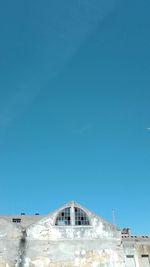 Low angle view of building against blue sky