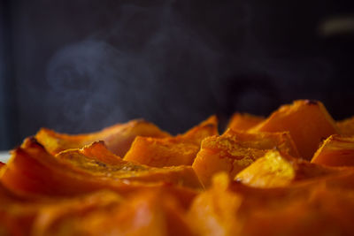 Close-up of orange fruit against black background