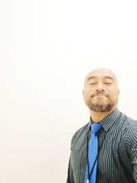 Portrait of young man against white background