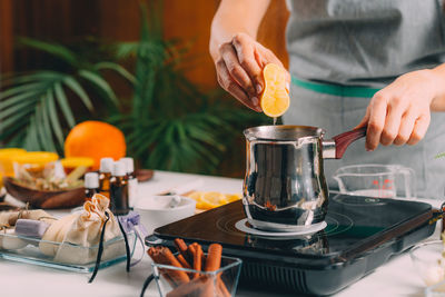 Woman squeezing lemon juice for homemade soap