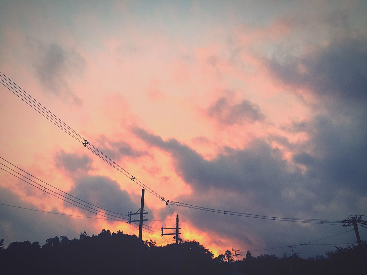 power line, electricity pylon, silhouette, sky, low angle view, sunset, power supply, electricity, cloud - sky, cable, connection, cloudy, fuel and power generation, beauty in nature, technology, tranquility, nature, cloud, scenics, power cable