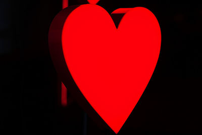 Close-up of red heart shape against black background