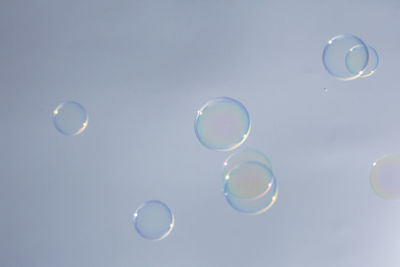 Low angle view of bubbles against sky