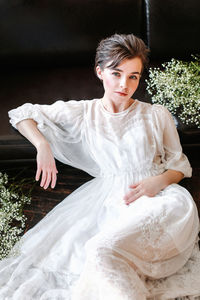 Portrait of young woman sitting outdoors