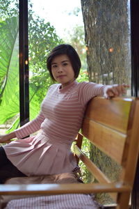 Portrait of smiling woman sitting outdoors