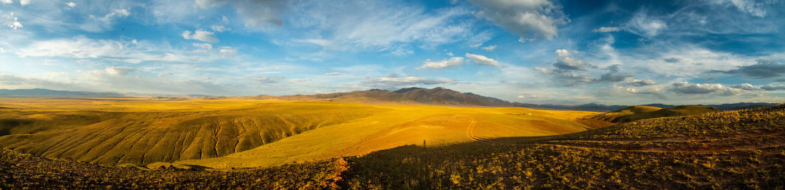 Panoramic view of landscape against cloudy sky