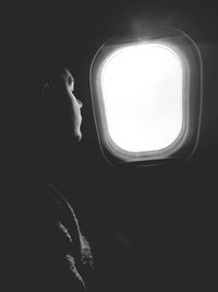 Man sitting in airplane window